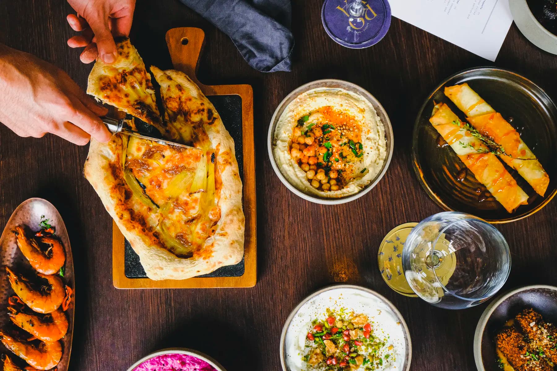 A spread of colourful mezze dishes on the table at Royâ